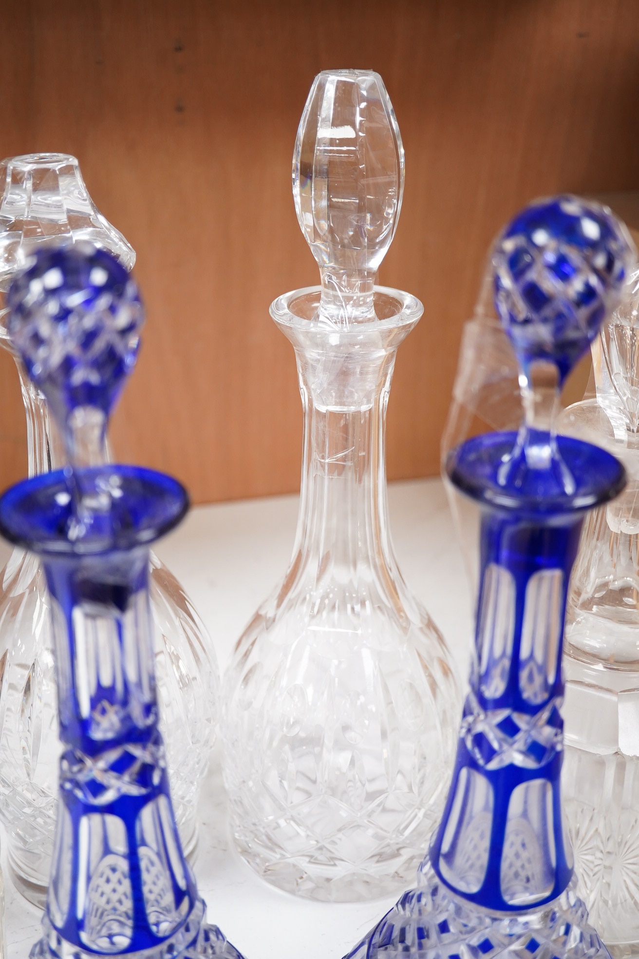 A near pair of blue flashed decanters and stoppers and four other decanters and stoppers, tallest blue flash decanter and stopper, 34cm high (6). Condition - fair to good